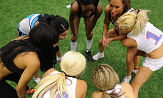 Lingerie Football League (LFL) aspiring players huddle as they take part in training drills during an open tryout session, for aspiring players to be selected to join the New York Majesty team, in Freeport, New York, May 14, 2009. The LFL, a 10-team nationwide American football league, features women playing football in their underwear, and will start in September 2009 for a 20-week season. In Freeport, just outside New York City, two dozen young women stripped to skimpy gym clothes, displayed their skills to trainers during the tryouts, in hope to be selected for the New York Majesty, one of the team in the upcoming league. AFP PHOTO/Emmanuel Dunand